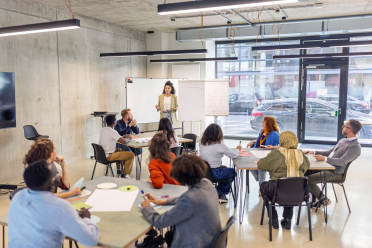 People in office listening to story from presenter